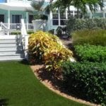 Front porch of beachfront home featuring DuPont™ ForeverLawn® Select Synthetic Grass