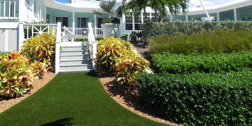 Front porch of beachfront home featuring DuPont™ ForeverLawn® Select Synthetic Grass