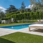Jessica Capshaw and Christopher Gavigan’s backyard pool surrounded by ForeverLawn Fusion