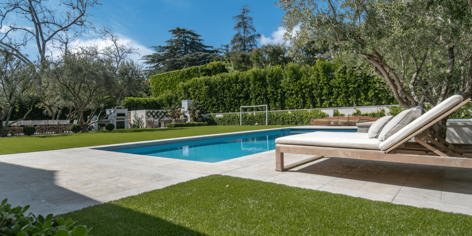Jessica Capshaw and Christopher Gavigan’s backyard pool surrounded by ForeverLawn Fusion