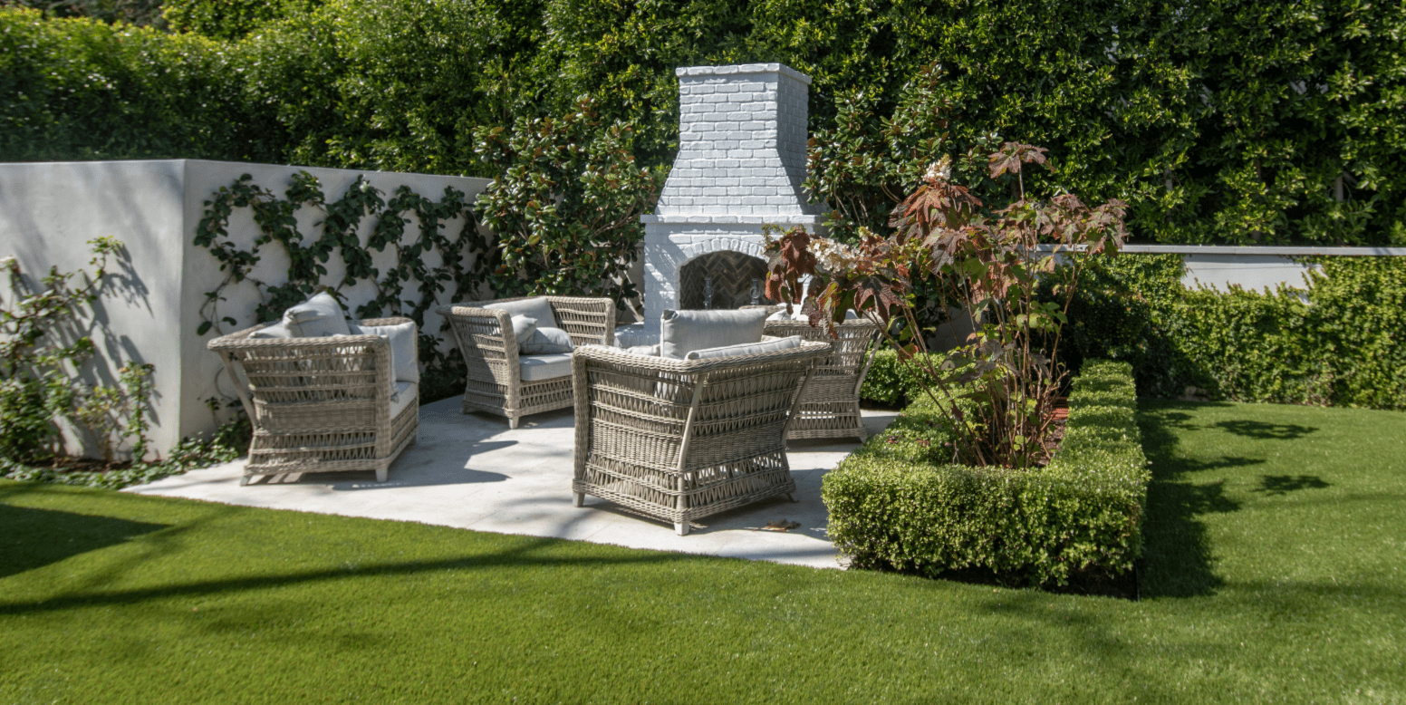 Jessica Capshaw and Christopher Gavigan’s backyard entertainment space featuring ForeverLawn Fusion