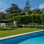 Jessica Capshaw and Christopher Gavigan’s backyard pool surrounded by ForeverLawn Fusion
