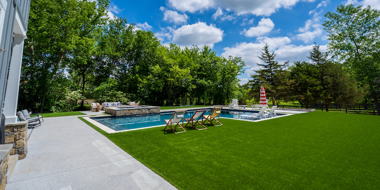 Downs residence backyard with pool featuring ForeverLawn synthetic grass installed by ForeverLawn Tulsa