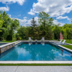 Downs residence backyard with pool featuring ForeverLawn synthetic grass installed by ForeverLawn Tulsa