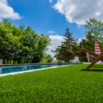 Downs residence backyard with pool featuring ForeverLawn synthetic grass installed by ForeverLawn Tulsa