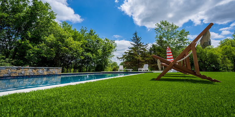 Downs residence backyard with pool featuring ForeverLawn synthetic grass installed by ForeverLawn Tulsa