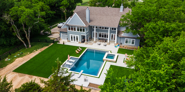 Downs residence backyard with pool featuring ForeverLawn synthetic grass installed by ForeverLawn Tulsa