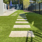 Ultra realistic and durable Fusion™ synthetic grass in a backyard pool area in Charleston