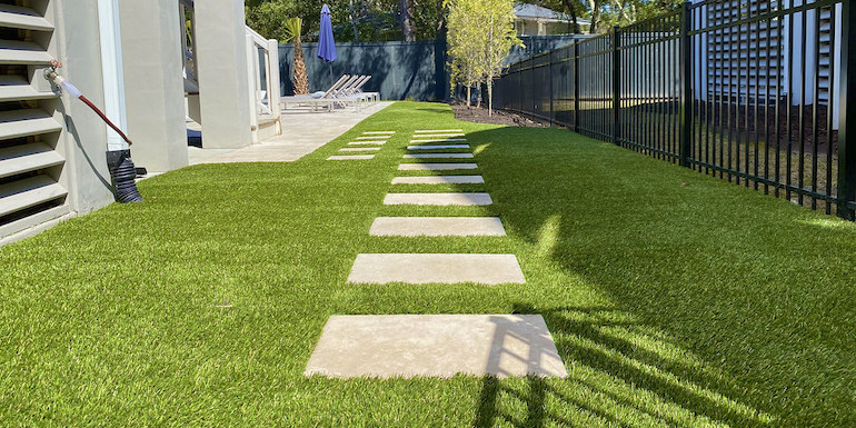 Ultra realistic and durable Fusion™ synthetic grass in a backyard pool area in Charleston
