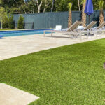Ultra realistic and durable Fusion™ synthetic grass in a backyard pool area in Charleston